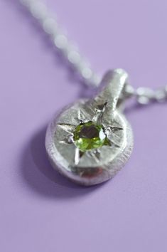 The delicate Fay Peridot pendant is the perfect way to add a touch of elegance to your everyday look. Crafted with Sterling Silver and a star-set Peridot, perfect for adding a bit of mystical charm. Use the drop down to select your chain preference. Details925 Sterling SilverRound cut PeridotHandcrafted in our studioEach piece is handmade so please allow for minor differences in texture and colour.Item #9904-01 Mixed Metal Pendants, Silver Peridot Jewelry As Gift, Modern Silver Peridot Jewelry, Peridot Necklace Silver, Silver Neckalce, Crystal Jewelry Ideas, Silver Pendant Necklace With Peridot, Styled Jewelry, Peridot Gemstone Pendant Necklace