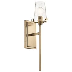 a wall light with a glass shade on the top and bottom corner, in an antique brass finish