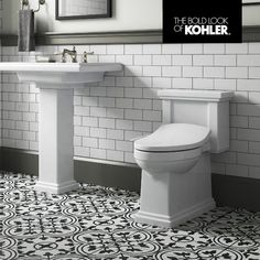 a white toilet sitting next to a sink in a bathroom under a mirror with the words kohler above it