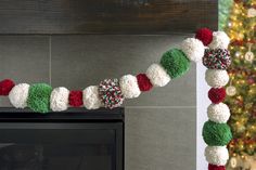 a decorated christmas garland is hanging on the fireplace