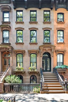 an apartment building with many windows and stairs