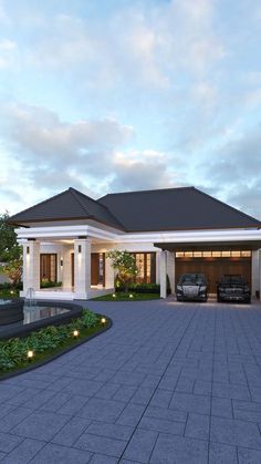 a car is parked in front of a house with a driveway and landscaping around it