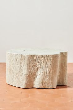 a white table sitting on top of a tiled floor