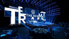 the new york international auto show stage is lit up with blue lights and black tables