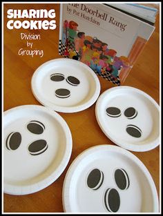 four paper plates with black footprints on them and a book about sharing cookies in the background