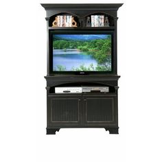 an entertainment center with a television on it's stand and two doors open to reveal a lake