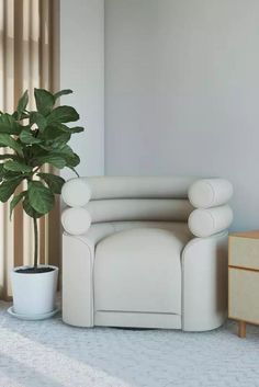 a white chair sitting next to a potted plant