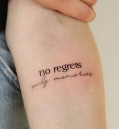 a woman's arm with the words no regents only memories tattooed on it