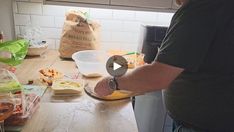 a man is making food in the kitchen while wearing a watch on his left wrist