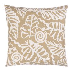 a beige and white pillow with leaves on it