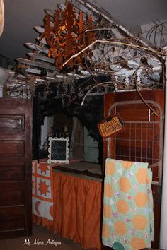 a bed room with a chandelier hanging from the ceiling next to a dresser