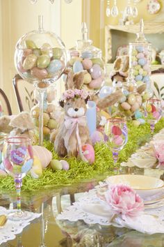 the table is set for easter dinner with bunny decorations