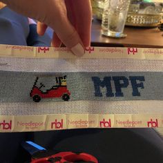 a person holding up a piece of paper with the word mpf printed on it