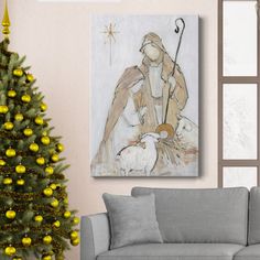 a living room with a christmas tree and a painting on the wall in front of it