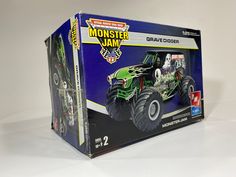 a toy truck with monster jam on it's back in a cardboard box,