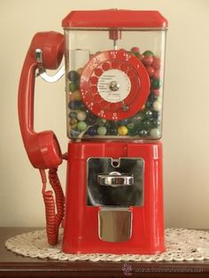 a red gummy machine sitting on top of a table