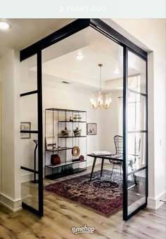 a living room with glass walls and wooden floors