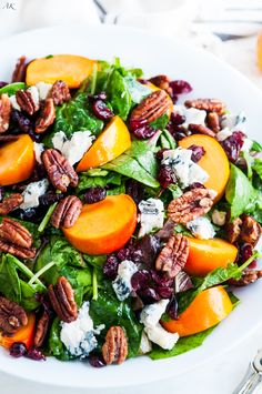 a white bowl filled with salad on top of a wooden table