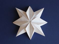 an origami star on a blue background