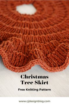 an orange knitted christmas tree skirt sitting on top of a white table with text overlay that reads, christmas tree skirt free knitting pattern