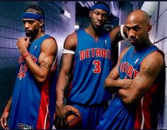 three basketball players are posing for a photo