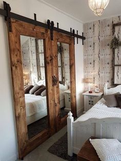 a bedroom with mirrored doors and white bedding