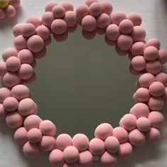 there is a mirror made out of pink and yellow candies in the shape of a heart