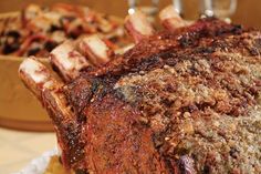 a large piece of meat sitting on top of a table next to other food items