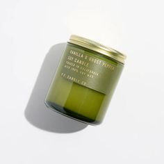 a green candle sitting on top of a white table