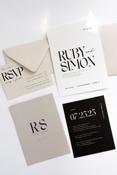 the wedding stationery is laid out on top of each other, including two envelopes and one letter