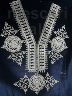 an embroidered piece with intricate designs on it's chest and neckline, in white thread