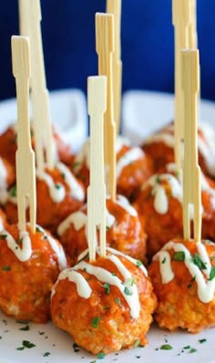 small appetizers with toothpicks sticking out of them on a white plate