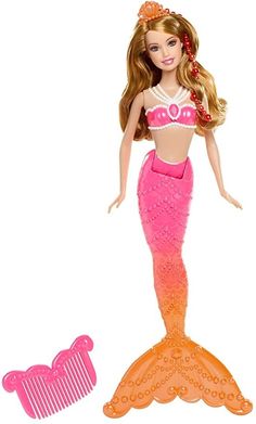 a barbie doll with a pink and orange dress next to a hair comb on a white background