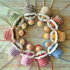 a group of knitted dolls sitting on top of a wooden floor