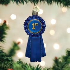 a blue ribbon ornament hanging from a christmas tree