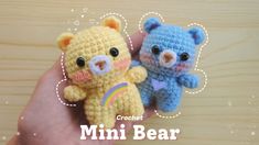 two small crocheted teddy bears sitting next to each other