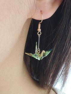 FOR BUNDLE DEALS:  https://artichouxcanada.etsy.com/listing/1633754962 https://artichouxcanada.etsy.com/listing/1633725324 Introducing our stunning handmade Origami Crane Earrings, meticulously crafted with the finest and most vibrant Japanese Yuzen/Chiyogami washi paper. These delightful earrings feature exceptional silver and gold plated hardware materials, adding a touch of elegance to the overall design.  With a wonderful range of captivating colors and patterns to choose from - including green, purple, yellow, pink, and blue - you're sure to find the perfect pair that complements your unique style. DIMENSIONS - Length from Earlobe: 3.5 cm (1.37 in) - Width (Wing to Wing): 2.8 cm (1.1 in) MATERIALS - Japanese Yuzen/Chiyogami washi paper - 14K Silver plated connector  - 14K Gold plated Paper Crane Earrings, Valentines Gift For Friends, Origami Candy, Unique Origami, Origami Lily, Crane Earrings, Earrings Paper