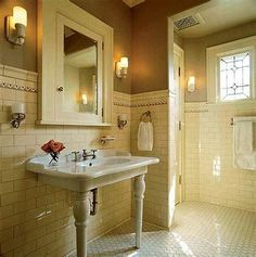 a bathroom with a sink, mirror and towel rack in the middle of the room