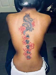 a woman with a dragon tattoo on her back