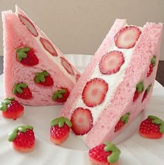 two slices of strawberry cake on a plate with strawberries