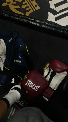 a pair of boxing gloves sitting on top of a bag