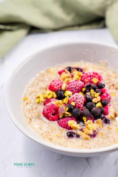 a bowl filled with oatmeal topped with berries and nuts