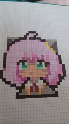 an image of a pixel art piece on a sheet of graph paper with pen and scissors next to it