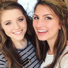 two young women are posing for the camera