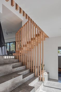 a staircase with wooden handrails in a modern home