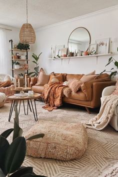 a living room filled with lots of furniture and plants on top of the rugs