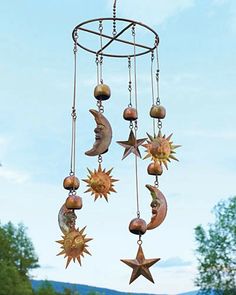 a wind chime with sun and moon decorations hanging from it