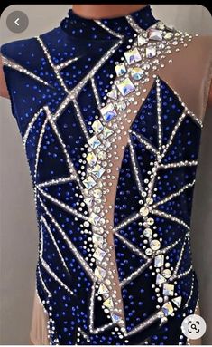 the back of a woman's leotard with blue and silver sequins