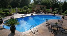 a backyard with a swimming pool and patio furniture