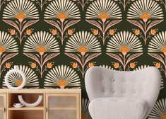 a white chair sitting in front of a wallpaper with an orange flower design on it